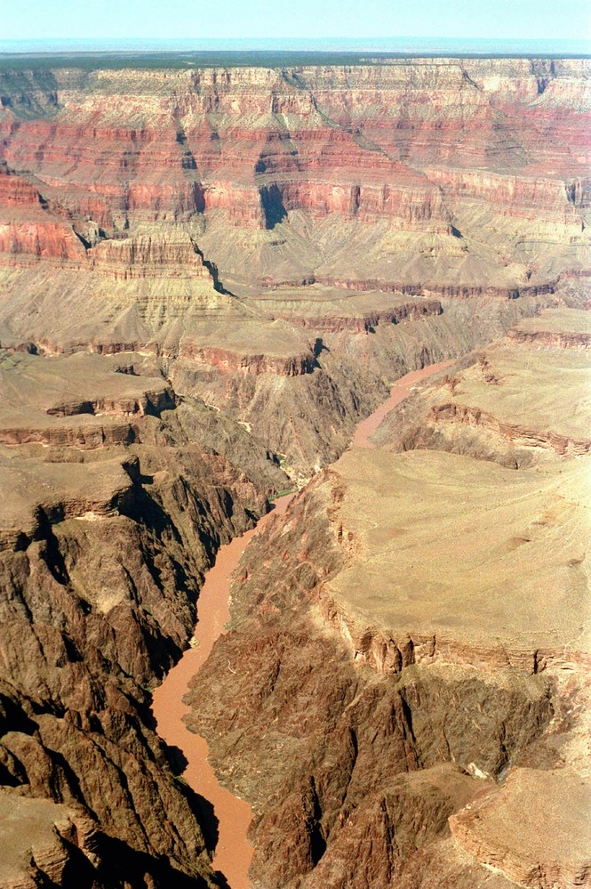 Aerial view of the Grand Canyon showcasing the river and rock formations.